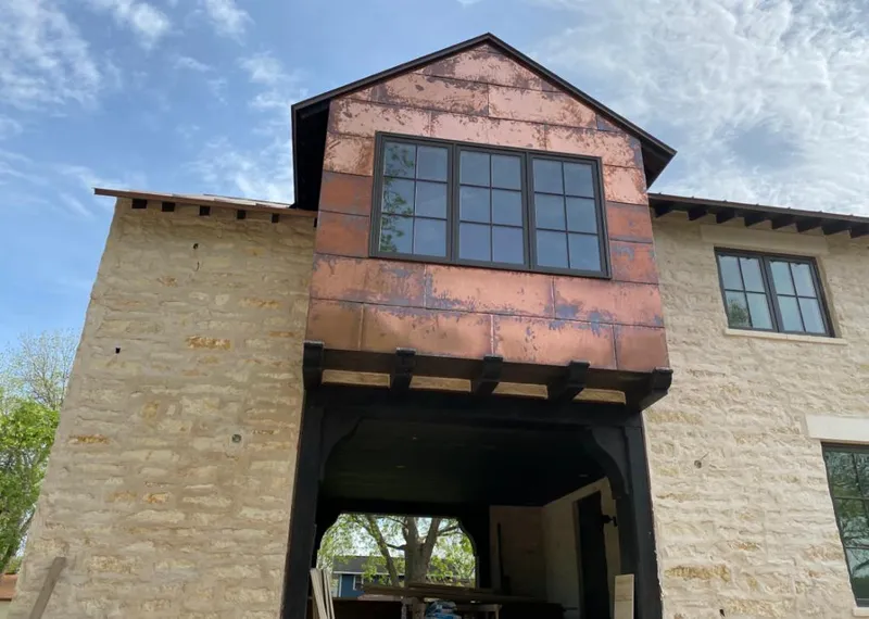 Copper metal panel facade on a stone building for Metal Roof Coating in Crookston